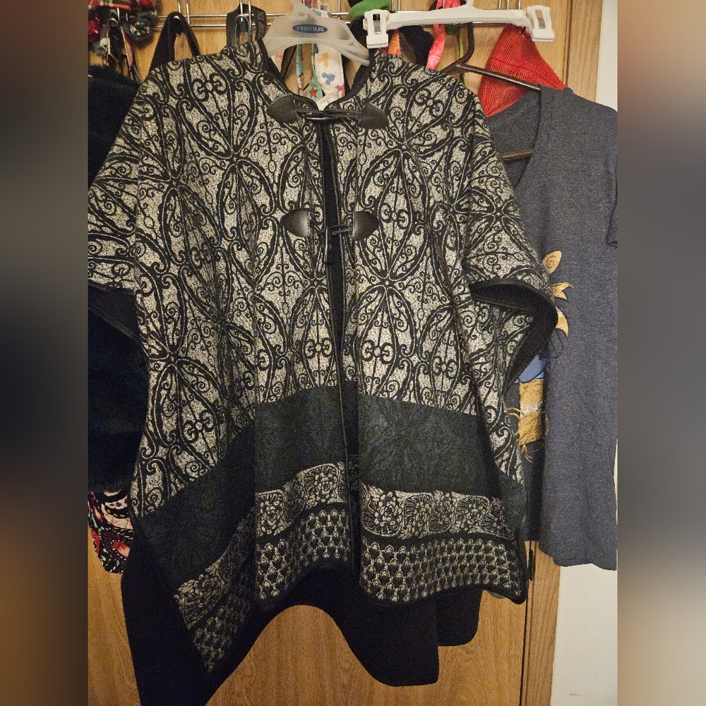 Hooded cloak with two toggle buttons. Used but still in good condition.
